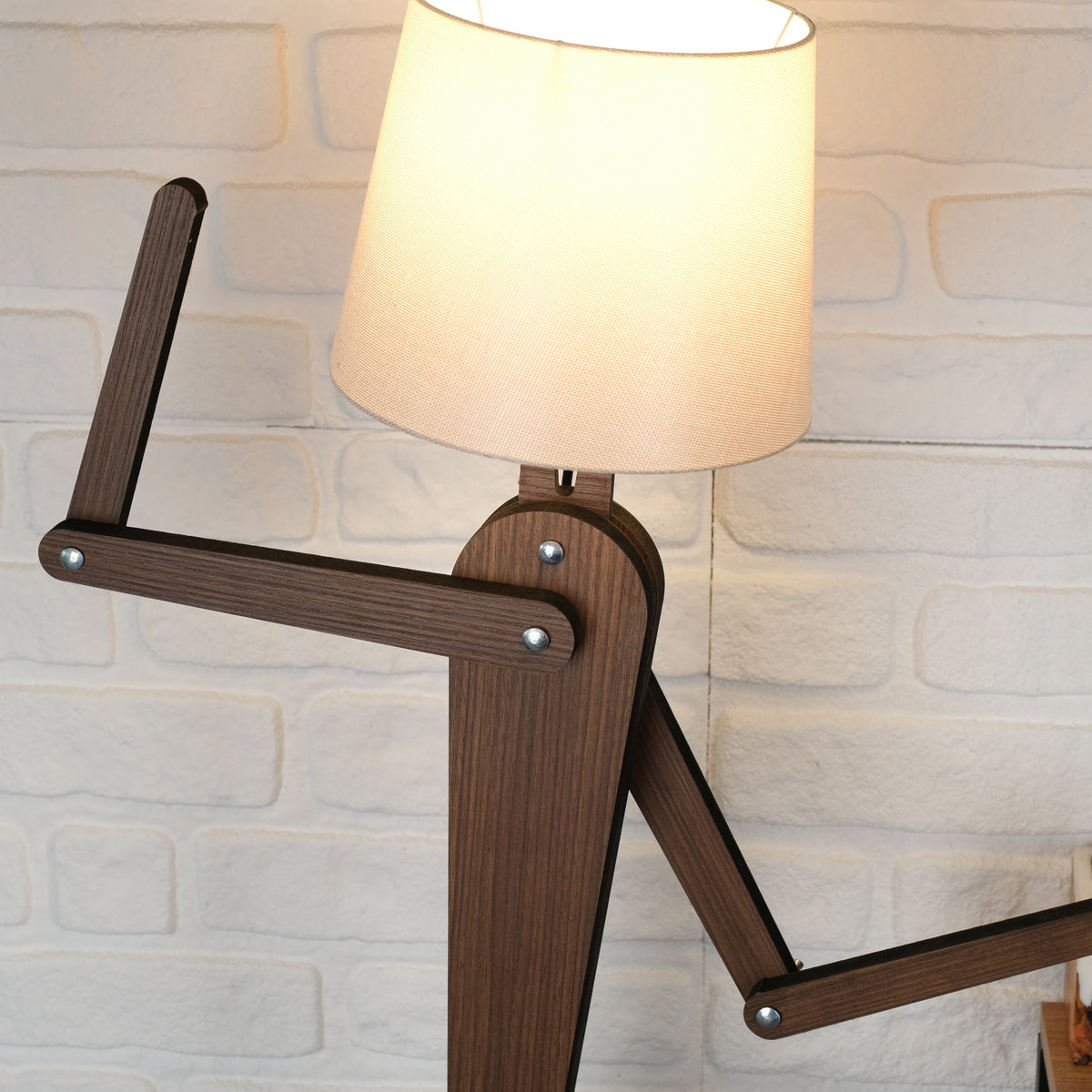 Handmade wooden floor lamp showcasing unique design with adjustable arm and soft fabric shade, ideal for home décor.