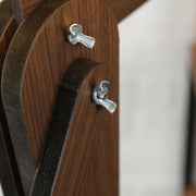 Close-up of handmade wooden floor lamp assembly showcasing unique design and metal fittings.