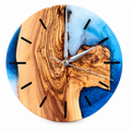 Azure Cape Olive Wood & Resin Wall Clock in blue and pearly white on a white background
