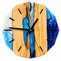 Azure Divide Olive Wood & Resin Wall Clock in blue and pearly white on a white background