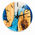 Blue Woodbanks Olive Wood & Resin Wall Clock in blue and pearly white on a white background