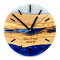 Engraved Tide Olive Wood & Resin Wall Clock in blue and white on a white background