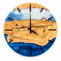 Golden Current Olive Wood & Resin Wall Clock in blue and pearly white on a white background