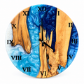 Roman Estuary Olive Wood & Resin Wall Clock in blue and white on a white background
