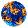 Sapphire Archipelago Olive Wood & Resin Wall Clock in sapphire blue on a white background